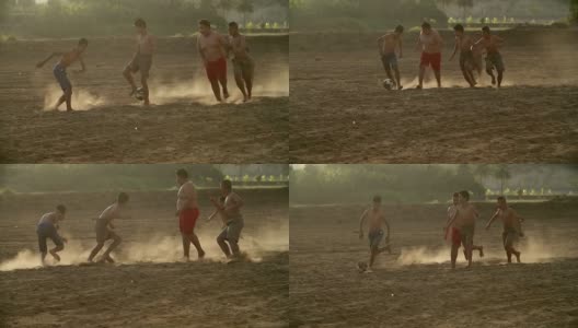 慢镜头，农村的孩子们在阳光明媚的日子里踢足球。高清在线视频素材下载