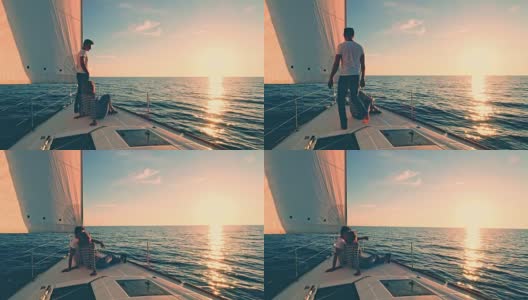 日落时分，一对夫妇在一艘帆船的甲板上休息高清在线视频素材下载
