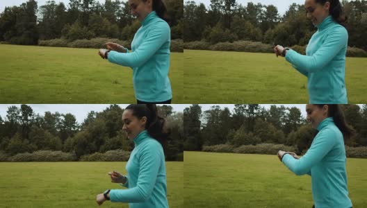 女性跑步者使用智能手表健身手表高清在线视频素材下载