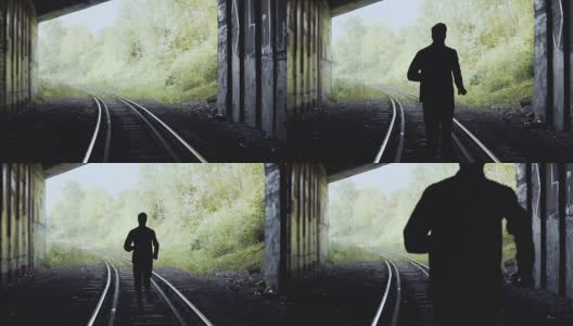 缓慢的运动。一个人在铁路上向前跑。后视图。抽象的轮廓。追随梦想的概念高清在线视频素材下载