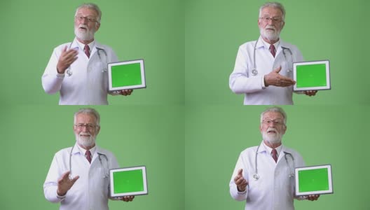 英俊的资深大胡子医生对绿色的背景高清在线视频素材下载