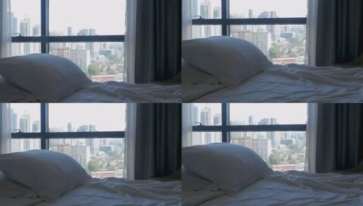 倾斜的床与枕头和一个现代城市的高楼大厦高清在线视频素材下载