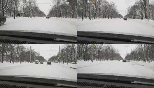 冬天的天气就在汽车路上——飘落的雪花高清在线视频素材下载
