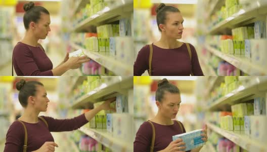 年轻女性从超市货架上选择湿巾。一个有白种人外貌的女孩在超市购物。HD，手推车，物品，超市内部高清在线视频素材下载