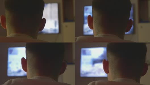 一个年轻人在游戏机上玩游戏的后视图高清在线视频素材下载