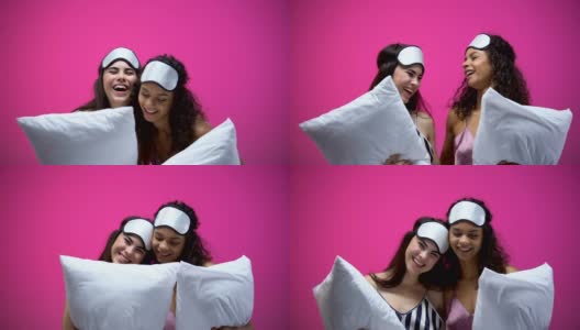两位女士穿着睡衣，戴着眼罩，抱着枕头，笑着休息高清在线视频素材下载