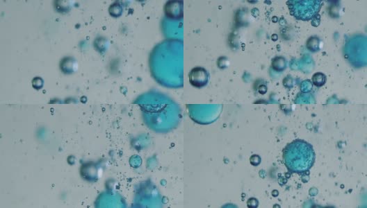 用显微镜对液体中蓝色微粒分子的慢镜头宏观分析，用于护肤美容化妆品的科学实验室研究高清在线视频素材下载