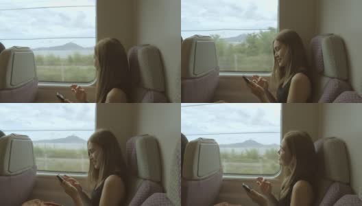 女性在高铁上拍摄外部景色高清在线视频素材下载