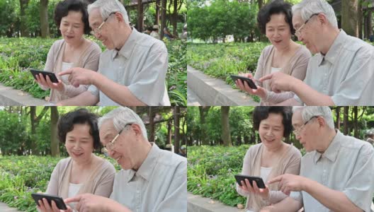 中国老年夫妇一起在户外看智能手机高清在线视频素材下载