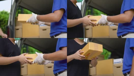 冠状病毒的概念。亚洲蓝色快递员戴着防护口罩和医用橡胶手套在发货前将包裹寄给客户。4k分辨率和慢动作拍摄。高清在线视频素材下载