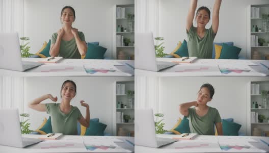 亚洲商业女性伸展身体放松，而工作的笔记本电脑在客厅在家里。高清在线视频素材下载