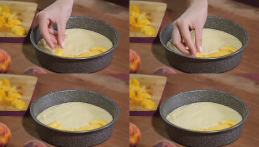 水蜜桃派的制作过程女人用手把新鲜的桃子放在面糊上。高清在线视频素材下载