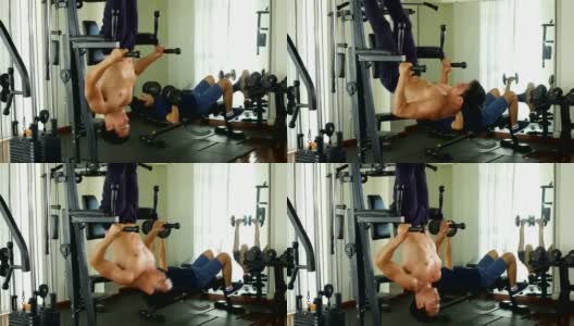 年轻的亚洲健美男在健身房锻炼腹肌，健康的生活理念高清在线视频素材下载