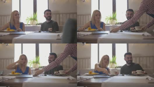 一对年轻的白人夫妇在咖啡馆里喝茶高清在线视频素材下载