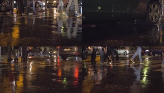 在城市的雨夜，人们在人行横道上。法国巴黎高清在线视频素材下载