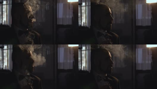 一个抽着雪茄，烟瘾很大的剪影男人高清在线视频素材下载