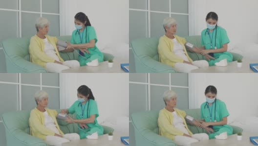 亚洲女护士做血压测量资深妇女病人在客厅在家。家庭医疗保健的概念。高清在线视频素材下载
