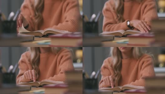 一段4k视频显示一名女子一边读课本一边翻书高清在线视频素材下载