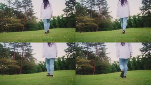 后视图腿的身体部分视频剪辑的年轻女子走在自然高清在线视频素材下载