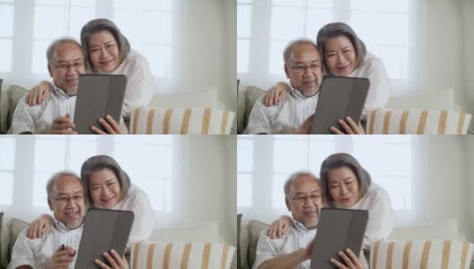 一对夫妇在Cozy Home一起使用数字平板电脑高清在线视频素材下载