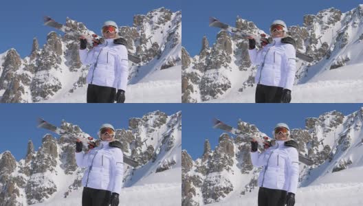 一位肩上扛着滑雪板的女子在山上欣赏大自然的美景高清在线视频素材下载