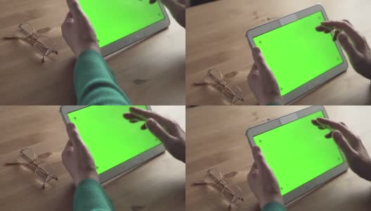 多莉:一位老年妇女手中的白色平板电脑(绿色屏幕)高清在线视频素材下载