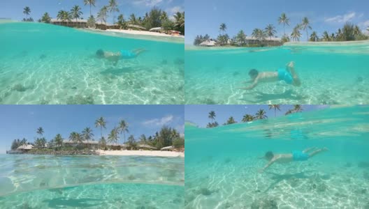 半水下:年轻的男性游客游泳在令人惊叹的海滨度假胜地附近。高清在线视频素材下载