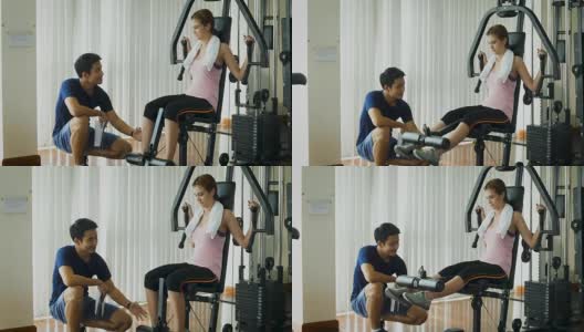 年轻的健身女士在健身房用负重器械做运动，健身训练理念高清在线视频素材下载