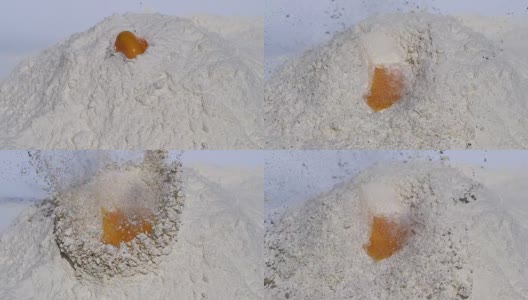 鸡蛋在白色背景下落入面粉，慢镜头高清在线视频素材下载