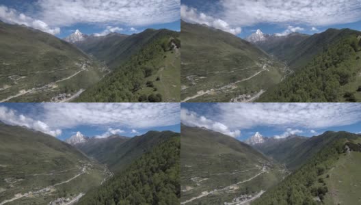 无人机缓缓地飞向四姑娘山(四姑娘山)，山谷中有一个藏族小村庄(四姑娘山镇)。拍摄于前往海子沟的徒步路线上。高清在线视频素材下载