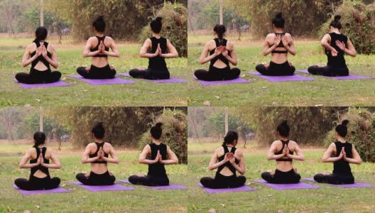一群亚洲妇女练习瑜伽在反祈祷姿势，背部和肩膀伸展在户外公园。高清在线视频素材下载