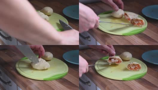 刚从烤箱里取出的热气腾腾的饺子被放在砧板上分割，里面用锋利的刀显示高清在线视频素材下载
