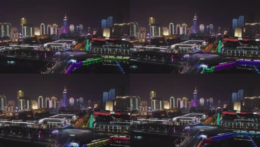 夜间时间照亮了青岛著名的奥林匹克湾广场交通街道航拍全景4k中国高清在线视频素材下载