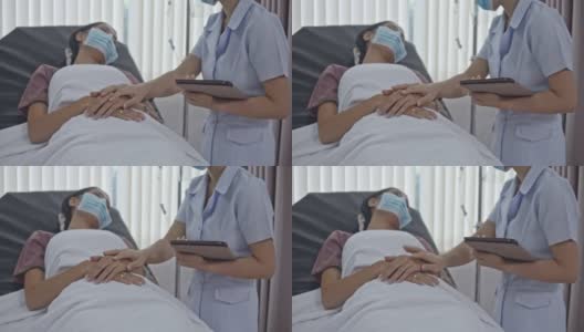 护士用防护口罩触摸病人的手，慢动作高清在线视频素材下载