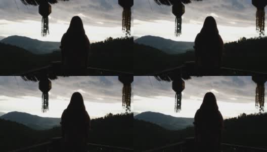 一个女旅行者的剪影在看一个美丽的山景高清在线视频素材下载