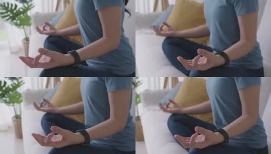 亚洲人早起健康生活平衡的好处瑜伽姿势在沙发上。高清在线视频素材下载