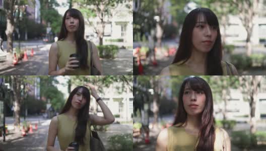身着黄色连衣裙的美女手捧一杯咖啡走在城市里高清在线视频素材下载
