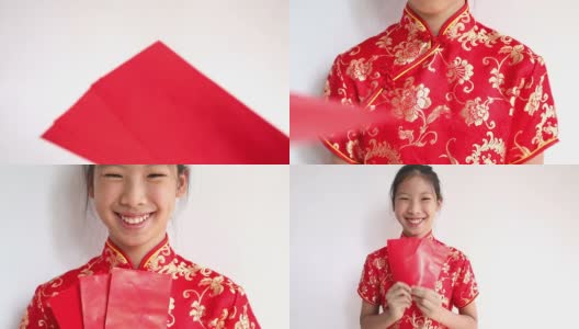 春节快乐。微笑的亚洲女孩拿着红包高清在线视频素材下载