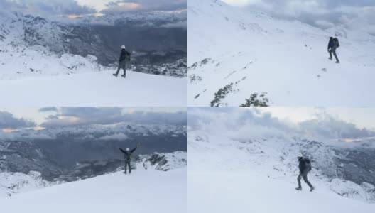 冬季登山运动员在到达山顶时举起双手高清在线视频素材下载
