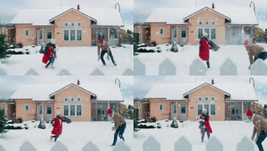 年轻美丽的夫妇互相扔雪球当雪落下。快乐的男人和女人在他们田园诗般的房子的院子里玩雪。家庭享受冬天。高清在线视频素材下载