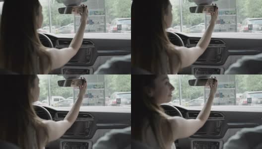 在车里，漂亮的女人看着后视镜高清在线视频素材下载