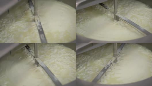 自动制酪机正在生产奶酪，旋转刀正在搅拌发酵后的白浆高清在线视频素材下载