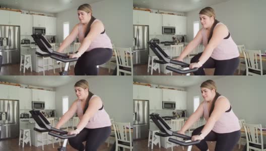 在家里使用健身自行车的妇女高清在线视频素材下载