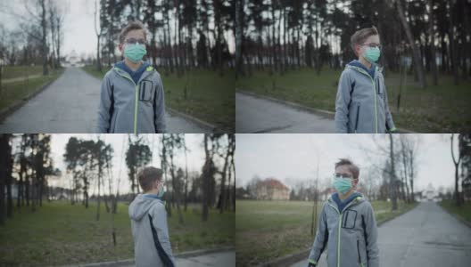 戴着防毒面具的小男孩在公园里散步高清在线视频素材下载
