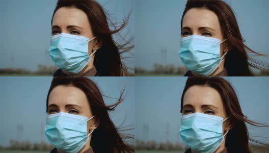 慢镜头悲伤的女子戴着医用口罩，蓝天下呼吸新鲜空气，为抗击冠状病毒而奋战高清在线视频素材下载
