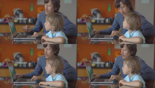 一个年轻人和他的小儿子在隔离期间坐在家里，在互联网学校用平板电脑学习。冠状病毒的概念高清在线视频素材下载