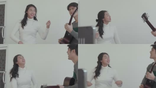 亚洲年轻情侣一起弹吉他跳舞;慢动作高清在线视频素材下载
