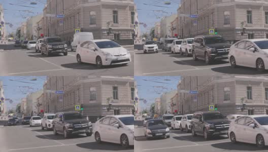 汽车停在有交通灯的十字路口。大城市里的汽车高清在线视频素材下载