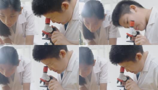 亚洲儿童穿着实验服，用显微镜做科学实验，在家学校实验室，教育生活理念。高清在线视频素材下载