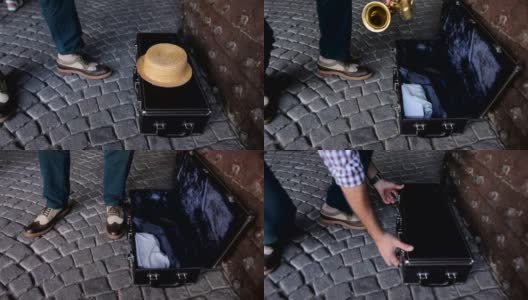 街头音乐家打开一个手提箱高清在线视频素材下载